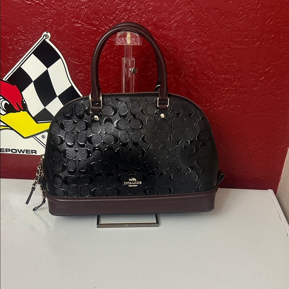 Coach Black and Brown Embossed Satchel comes with unbranded strap that matches.